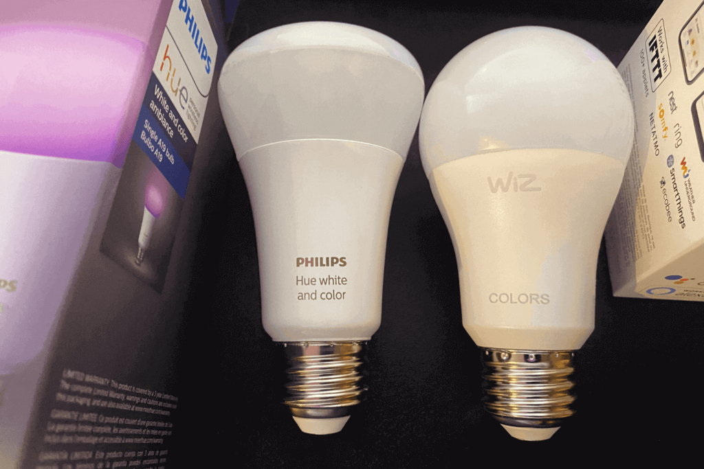 A Philips Hue bulb and a WiZ bulb side-by-side