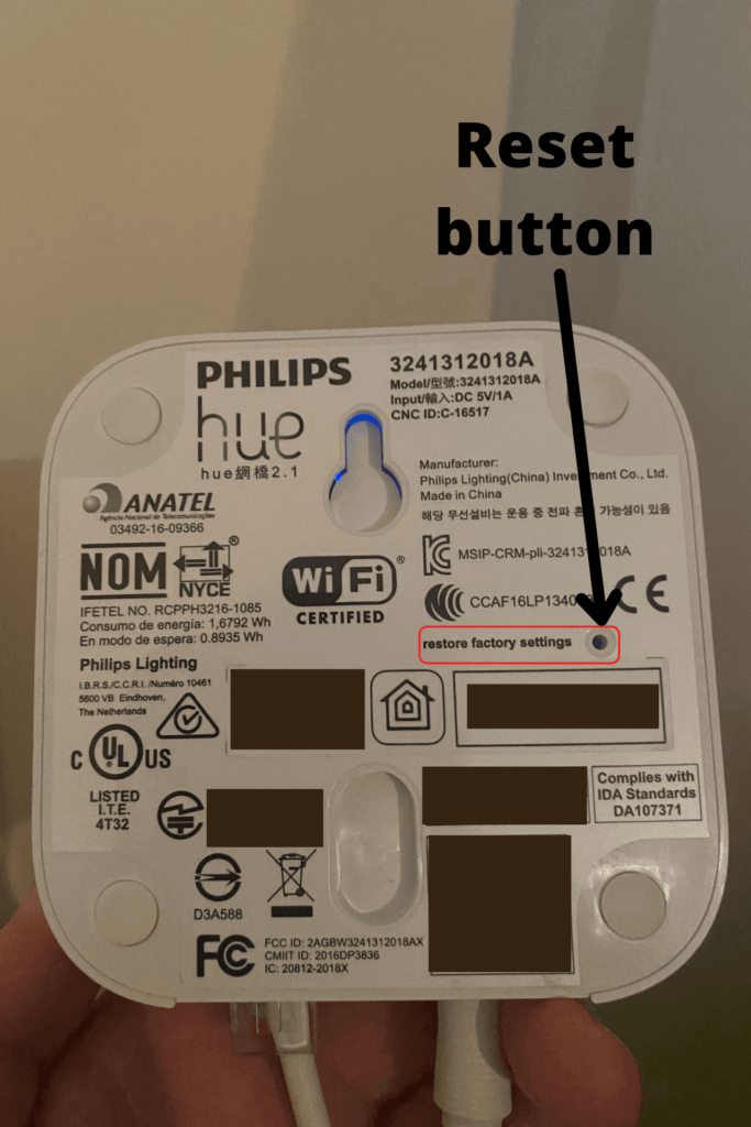 You can find the reset button on the back of your Philips Hue Bridge.