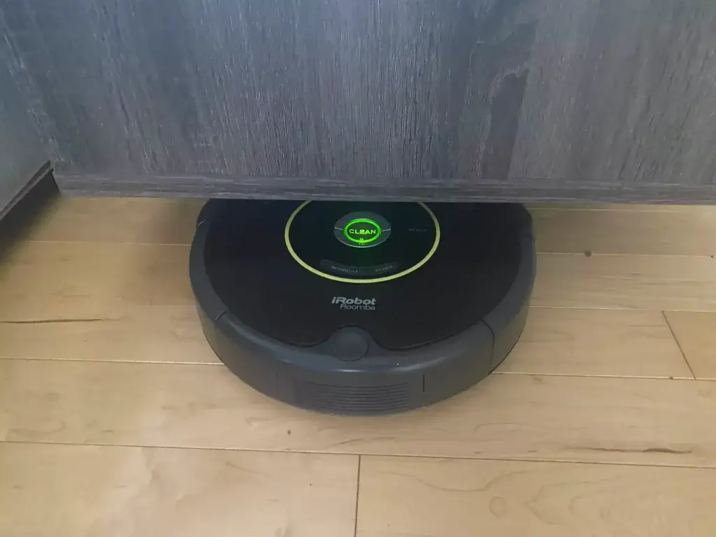 A robot vacuum getting stuck under a coffee table