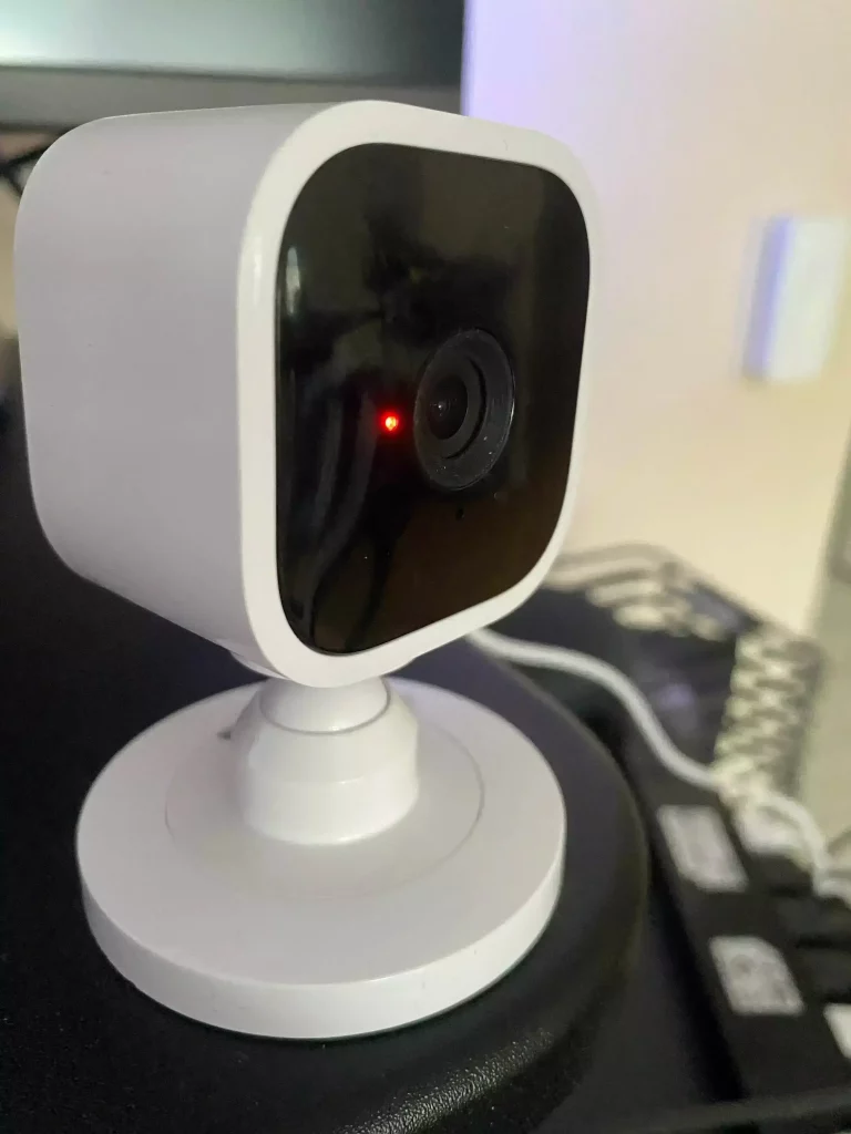 A Blink Mini camera flashing a red light, likely indicating a network connection issue