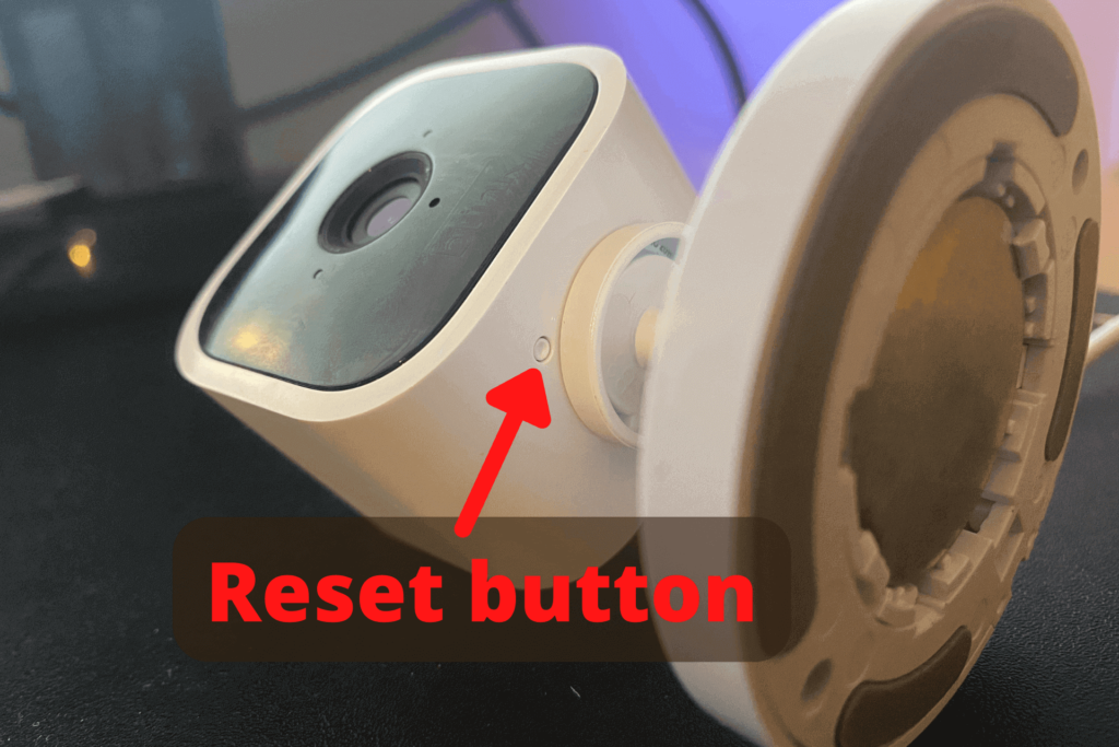 The reset button on the bottom of a Blink Mini camera