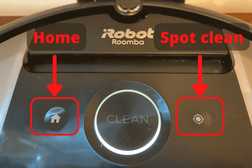 The Roomba i7 and its buttons, highlighting the home and spot clean buttons.